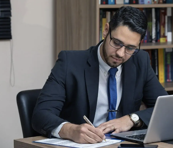 Lawyer signing document with smile face and laptop